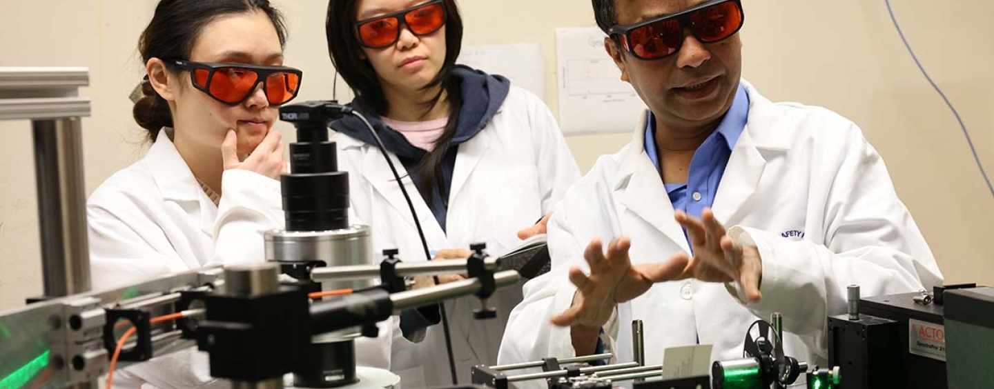 Prof. AKM Newaz in laboratory with student researches.